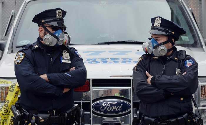 New York City Police Department officers wear masks at the scene of explosion.