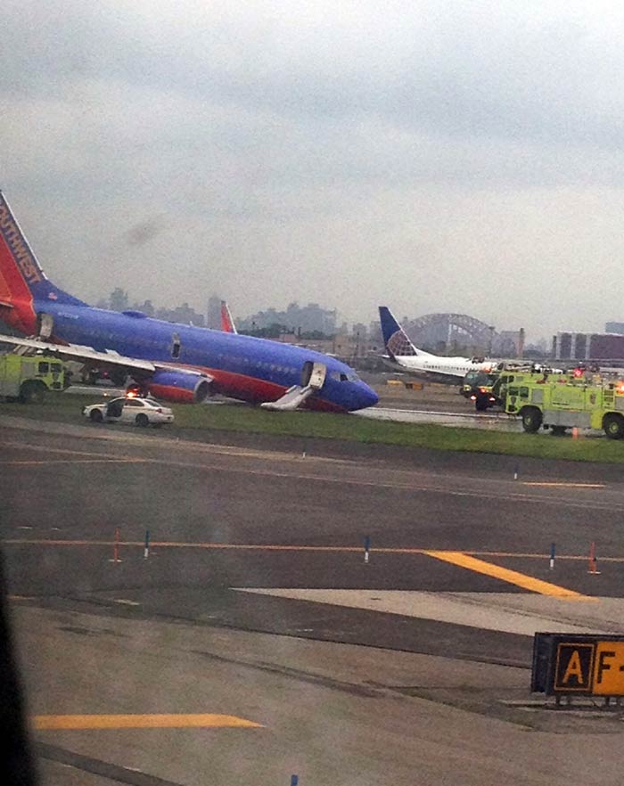 The airport was temporarily closed, but one of two runways was operating shortly after 7 p.m., and Bosco said the Port Authority was hoping to have the airport fully open by Tuesday morning. <br><br>
Photo credit: AP