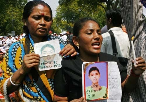 The Central Bureau of Investigation (CBI) on March 22, 2007 charged businessman Moninder Singh Pandher and his servant, Surinder Koli, with the abduction, rape and murder of several people, mainly children, in the case dubbed the 'House of Horrors'.

Here in this picture, a relative of missing child Anita Kaur, (R), and Geeta Pal, mother of missing child Rakesh Pal, (L) hold photographs of their children as they join in a rally at the culmination of the South Asian March Against Child Trafficking organised by Bachpan Bachao Andolan in New Delhi. (AFP Photo)