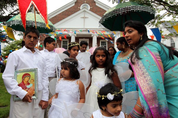 Young girls dress as winged angels for the procession. (NYT Photo)