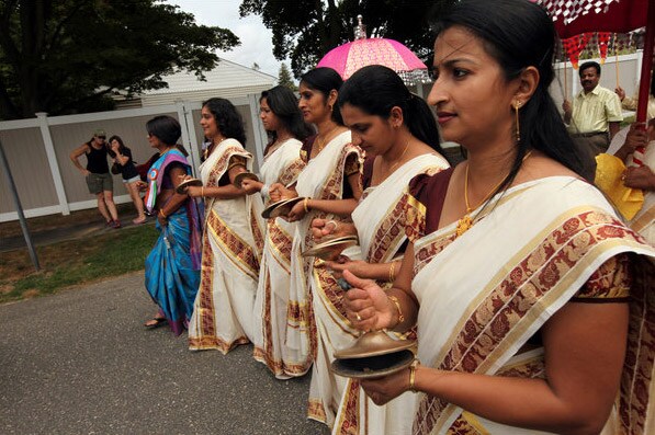 Women in the procession keep time with little brass cymbals called Ilathalam. (NYT Photo)