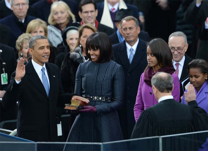 Barack Obama was publicly sworn in Monday for a second term as US president, again shouldering the power and burdens of office in testing times, before a flag-waving crowd of hundreds of thousands.</br></br>
Image courtesy: AFP