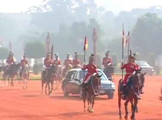 The Obamas arrive for a ceremonial reception at the Rashtrapati Bhavan, flanked by guards on either side of their car.