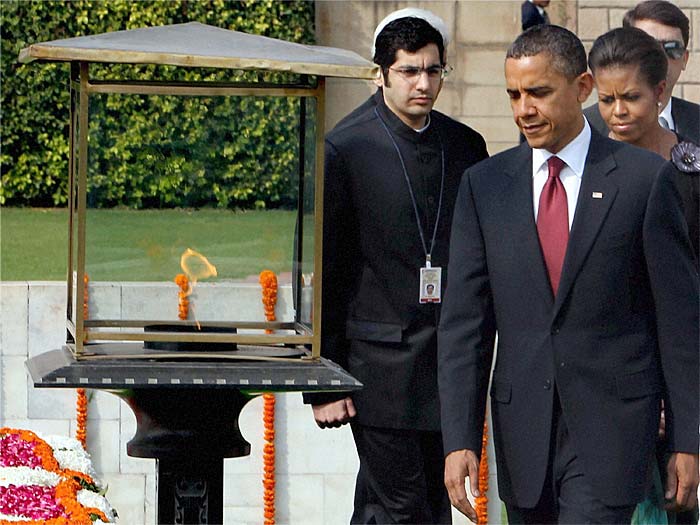 US President Barack Obama and First Lady Michelle Obama paying homage at the memorial of Mahatma Gandhi at Rajghat in New Delhi on Monday. (PTI Photo)