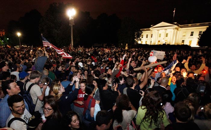 People are seen celebrating as the news breaks out in front of the White House. (Photo: AP)