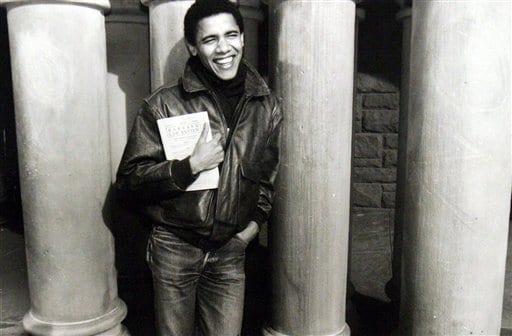 <b>Posing perfect:</b> This undated photo shows Obama while a student of Harvard Law School, where he became the first black president of the Harvard Law Review, of which he is holding a copy.