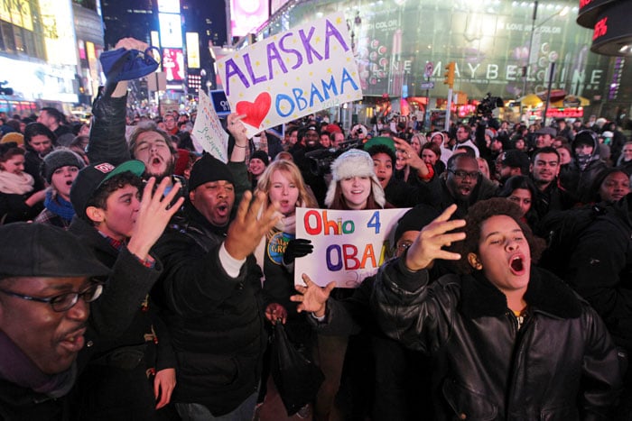 Four more years ? Obama supporters hold up four fingers.