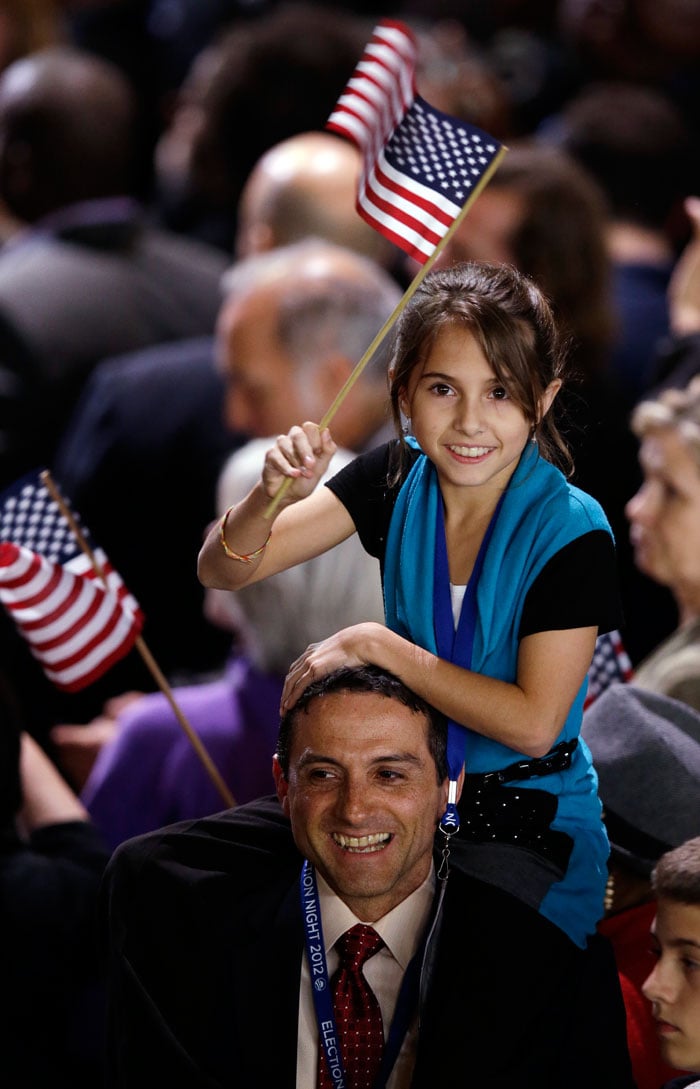 A young supporter of Obama waves a flag.