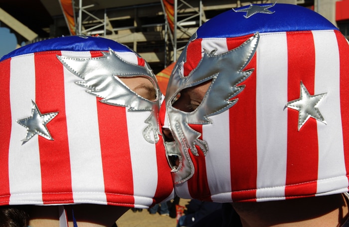 <b>FLAGGING IT OFF: </b>US fans in their match against Slovenia...show their patriotic side....and Kiss their way to the knock out stage. (AP Photo)