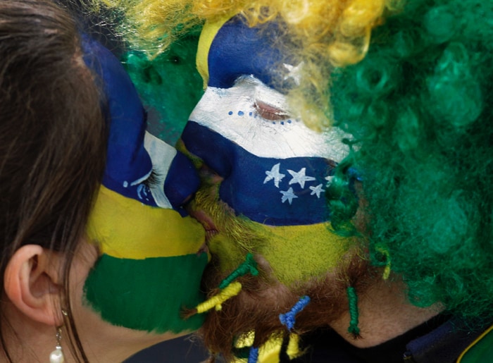 <b>SEALED WITH A KISS: </b> Brazil fans kiss to celebrate the victory of Brazil over Ivory Coast at Soccer City in Johannesburg. (AP Photo)