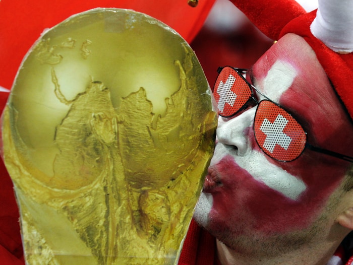 <b>YET ANOTHER: </b>A Swiss fan kisses replica World Cup trophy during the World Cup group H soccer match between Spain and Switzerland. (AP Photo)