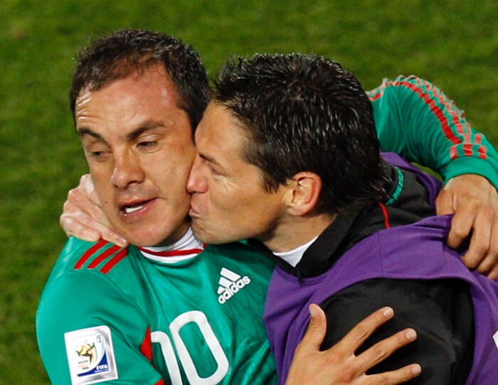 <b>AFTER A GOAL, PDA ON THE FIELD: </b>Mexico's Cuauhtemoc Blanco, left, is kissed by a teammate after scoring a penalty goal during the World Cup group A soccer match between France and Mexico. (AP Photo)