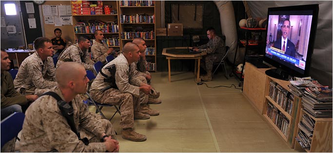 Marines in Afghanistan watch President Obama's speech. (Photo courtesy: New York Times)