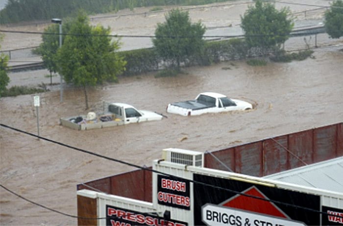 <b>Vehicles abandoned:</b> Flash floods swept through the northeastern Australian community Monday, overturning cars and flinging a van against several trees as relentless rains brought more misery to a region battling its worst flooding in decades. (AP Photo/ABC)