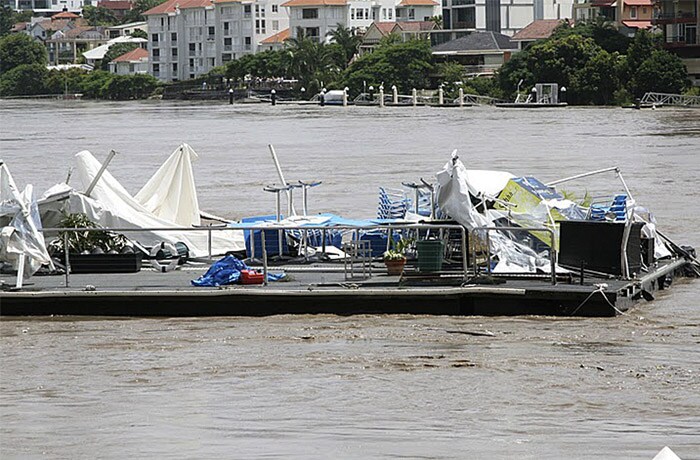 <b>Floating away:</b> The remains of a floating restaurant called Drift Cafe is swept down the Brisbane River Wednesday, Jan. 12, 2011, as floodwaters surge through Brisbane, Australia. (AP Photo)