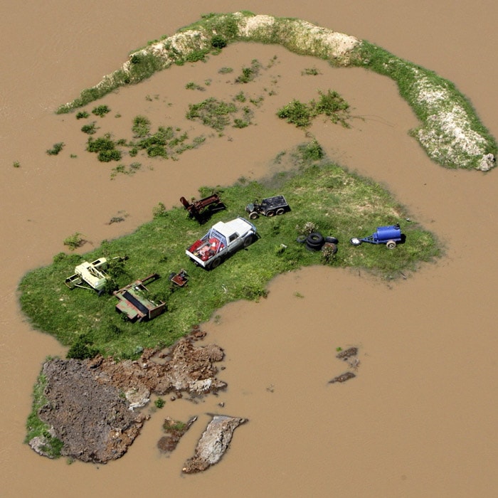<b>Marooned:</b> In this Tuesday, Jan. 4, 2011 photo, an island is formed by flood water stranding vehicles and other equipment in Rockhampton, Australia. (AP Photo)