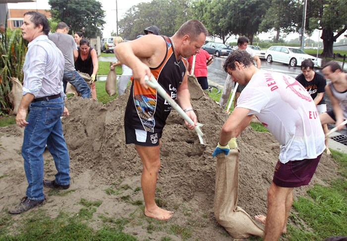 <b>Preparing for the worst:</b> Local residents fill bags with sand to use as protection as the Brisbane river burst its banks to cause widespread flooding in Brisbane, Australia, on Tuesday, Jan. 11, 2011. Residents in low-lying regions of the state capital of Brisbane were urged to sandbag their homes and later told to move to higher ground. (AP Photo)