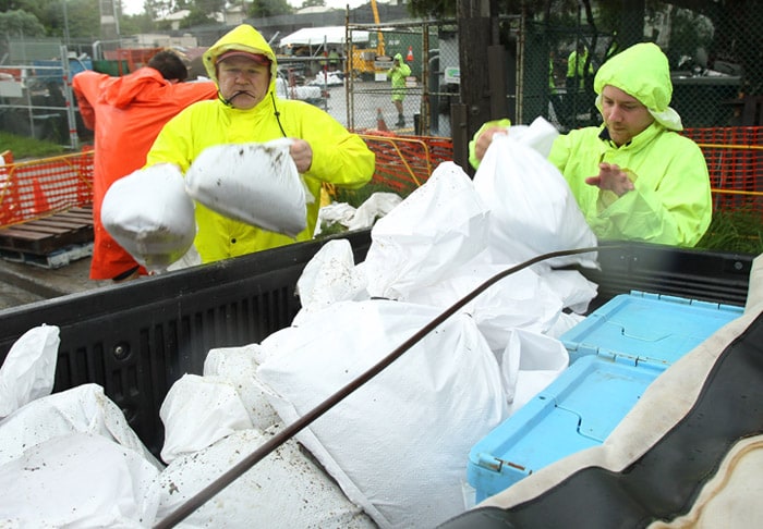<b>Bracing for more to come?</b> Volunteers help fill a vehicle with sandbags as the Brisbane river burst its banks to cause widespread flooding in Brisbane, Australia, on Tuesday, Jan. 11, 2011. Queensland has been in the grip of its worst flooding for more than two weeks, after tropical downpours across a vast area of the state covered an area the size of France and Germany combined. (AP Photo)