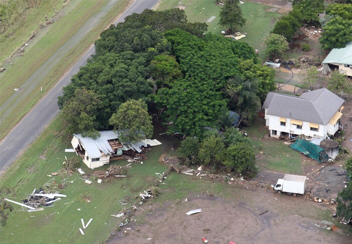 <b>In pieces:</b> A house lies destroyed under a tree in Brisbane, Australia, Wednesday, Jan. 12, 2011. Deadly floodwaters that have cut a swath across northeastern Australia flowed onto the streets of the nation's third-largest city, forcing people to flee suburbs and skyscrapers. (AP Photo)