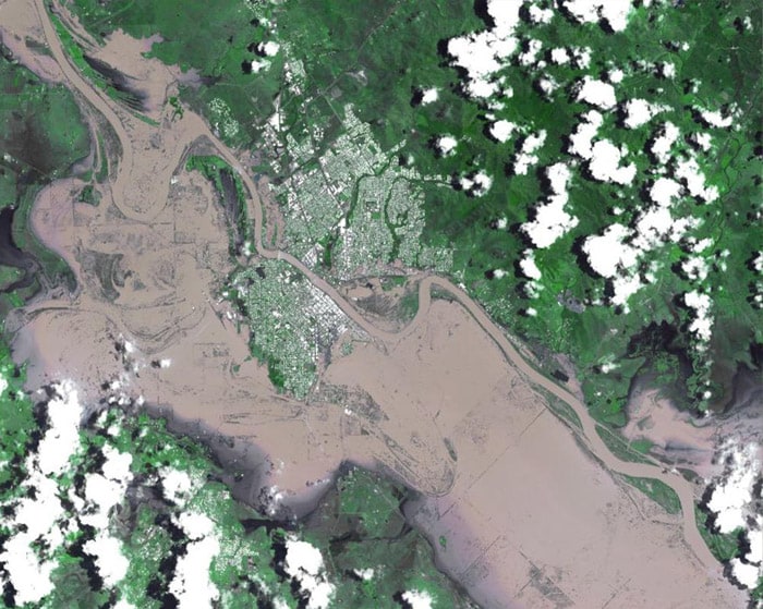<b>The size of Germany and France combined:</b> This image provided by NASA shows the inundated city of Rockhampton, Queensland, Australia. Heavy rains that began in late December led to the continent's worst flooding in nearly a half century, at its peak inundating an area the size of Germany and France combined. Rockhampton is the largest city affected by the current flooding. Both the airport and major highways are underwater, isolating the city. In this natural color rendition, muddy water is brown, and shallow, clearer water is gray. Vegetation is depicted in various shades of green, and buildings and streets are white. (AP Photo)