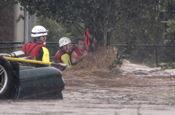 <b>In the nick of time:</b> A man is rescued by emergency workers after he was stranded clinging to a tree on a flooded street in Toowoomba, Australia, during a flash flood Monday, Jan. 10, 2011. (AP Photo/ABC)