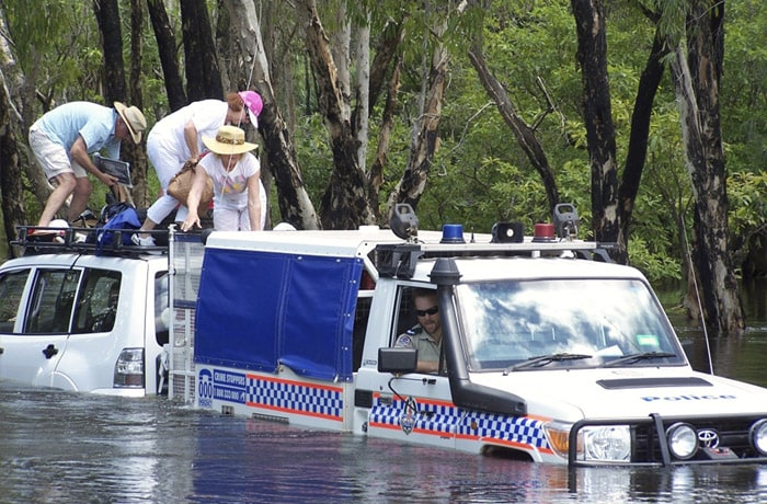 <b>Ferried to safety:</b> In this photo released by the Northern Territory Police, four German tourists are safely rescued from the flooded Magela Creek, near Jabiru, Australia, Monday, Jan. 3, 2011. Drenching rain that started before Christmas has flooded an area the size of France and Germany combined. (AP Photo)