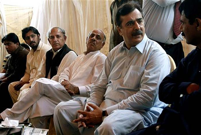 Pakistan's former Prime Minister Yousuf Raza Gilani, sits with people visiting his residence to console over his son's abduction in Multan, Pakistan on Thursday.