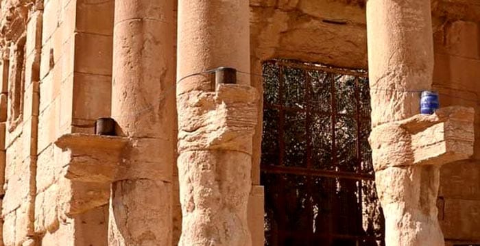 The photos show a large explosion apparently as the temple was blown up, and then a pile of rubble at its former location.