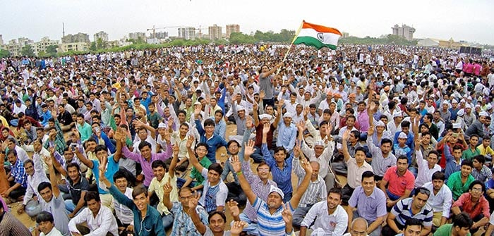 People of Patel ( Patidarl community ) seat atop a police bus during the Kranti rally (revolution march) to press for their demands for reservation, at GMDC Ground.