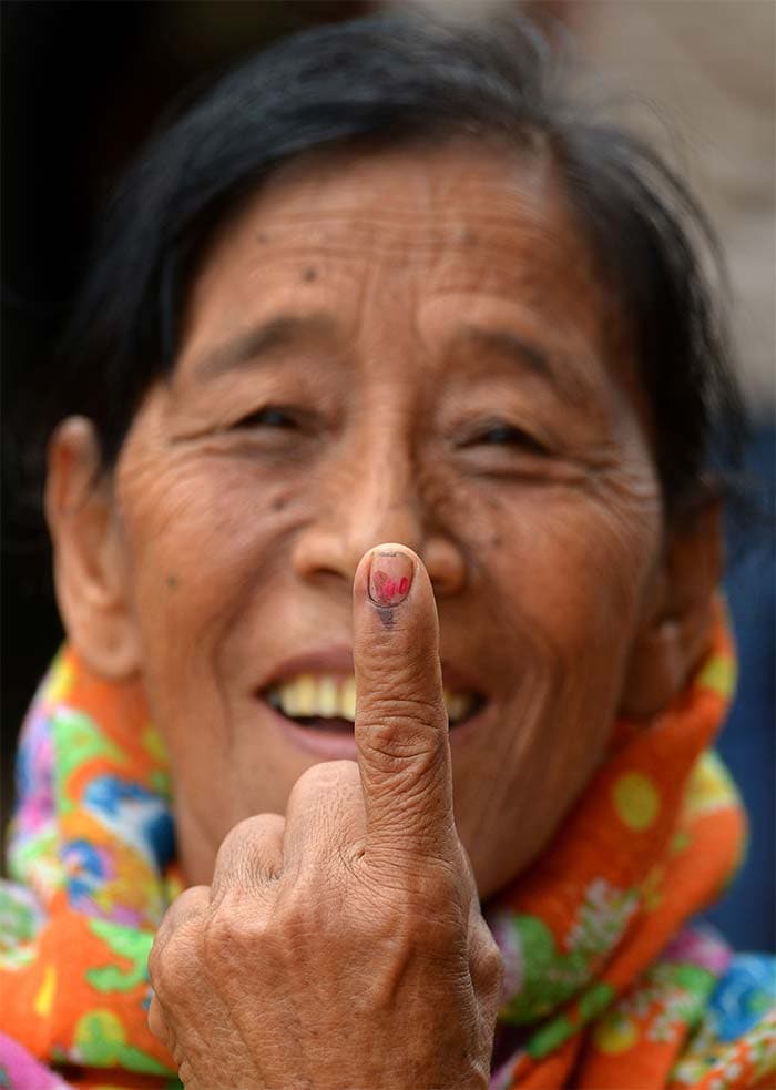 An elderly Naga woman holds up her ink-marked finger after casting her vote during the second phase of Lok Sabha election in Dimapur, in the north eastern state of Nagaland.