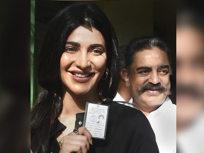 Makkal Needhi Maiam (MNM) Founder-President Kamal Haasan with his daughter and actress Shruti Haasan and other voters wait in a queue to cast vote during the second phase of the general elections, at a polling station in Chennai.