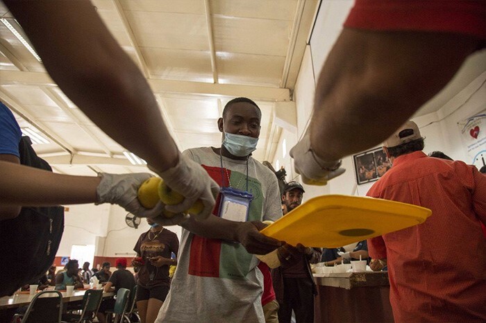 A Haitian migrant receives food at a shelter where he awaits for his immigration resolution in Monterrey, Mexico