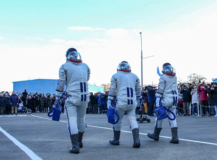 Cosmonaut Anton Shkaplerov (C), actress Yulia Peresild (L) and film director Klim Shipenko walking to board the Soyuz MS-19 spacecraft prior to its launch at the Russian-leased Baikonur cosmodrome.