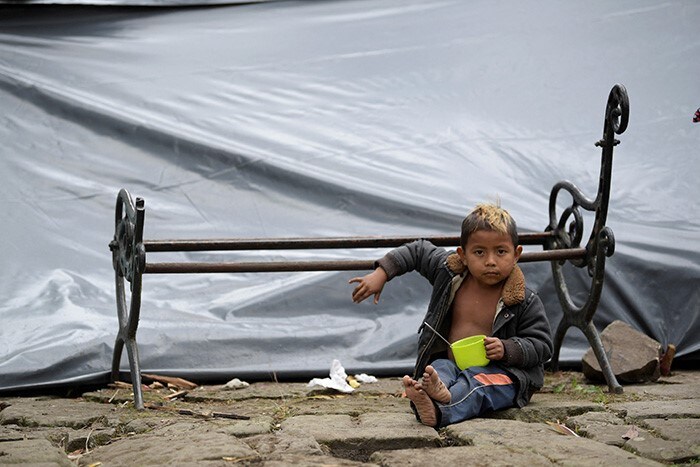 A Colombian Embera indigenous boy is seen in a makeshift shelter at National park in Bogota.