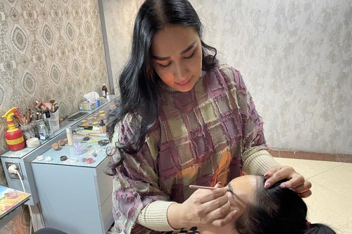 A beautician applies make-up to a customer at a beauty salon in Kabul. It is one of the last places in Kabul where women can meet outside their households, a bubble of freedom and even frivolity away from the gaze of men.