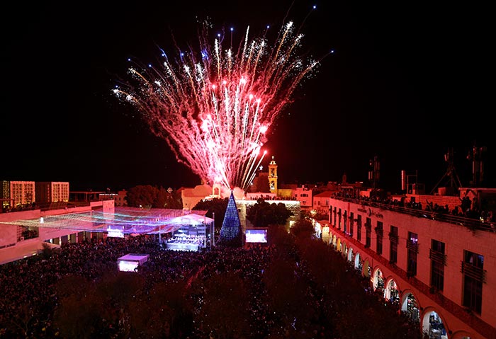 Fireworks light the sky to mark the lighting of a Christmas tree at the Manger Square near the Church of the Nativity.