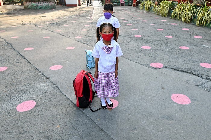 Kindergarten students wait in line before classes at school in Taguig city, suburban Manila, Indonesia.