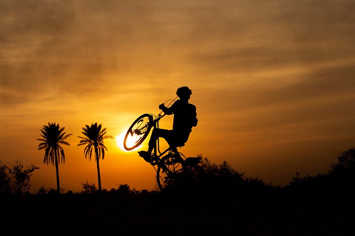 An Iraqi youth rides his bicycle in the Nahr Bin Omar village in the southern Basra governorate.