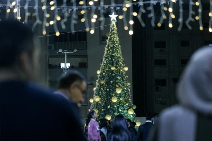 People light up the Christmas tree in Gaza City.