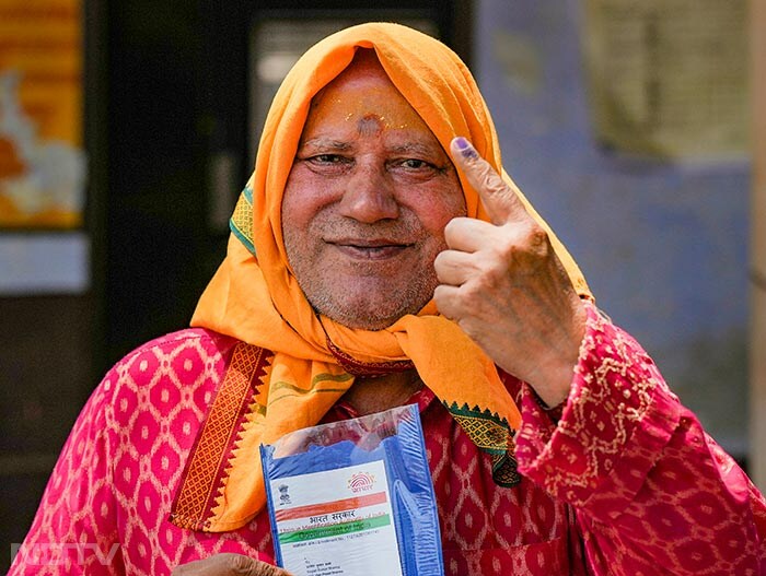 An elderly voter shows her finger marked with indelible ink after casting vote for the third phase of Lok Sabha elections UP's in Hathras