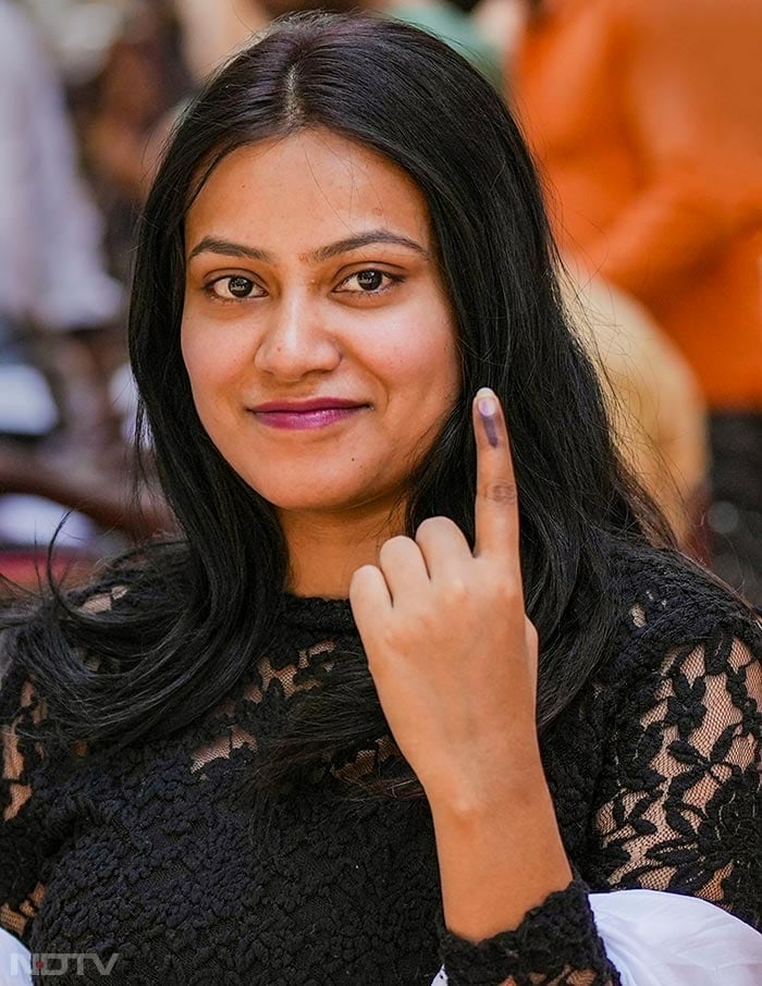 A first-time voter shows her finger marked with indelible ink after casting vote for the third phase of Lok Sabha polls in Uttar Pradesh.