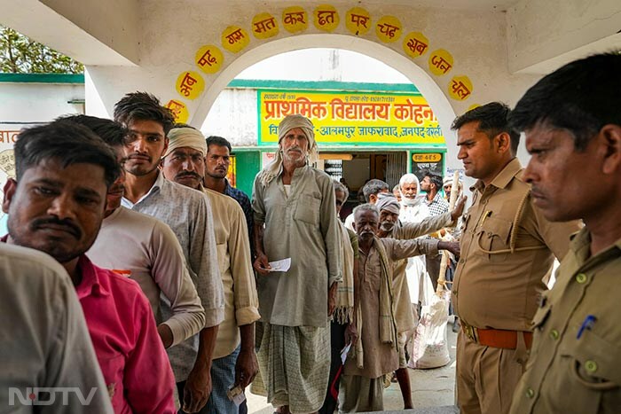 People wait to cast their vote during the 3rd phase of Lok Sabha elections in Bareilly.