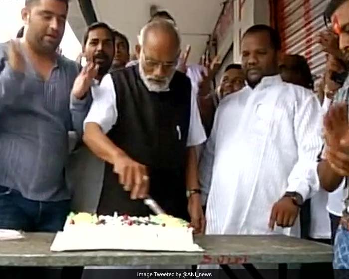 Narendra Modi's look alike cuts cake on the PM's birthday.