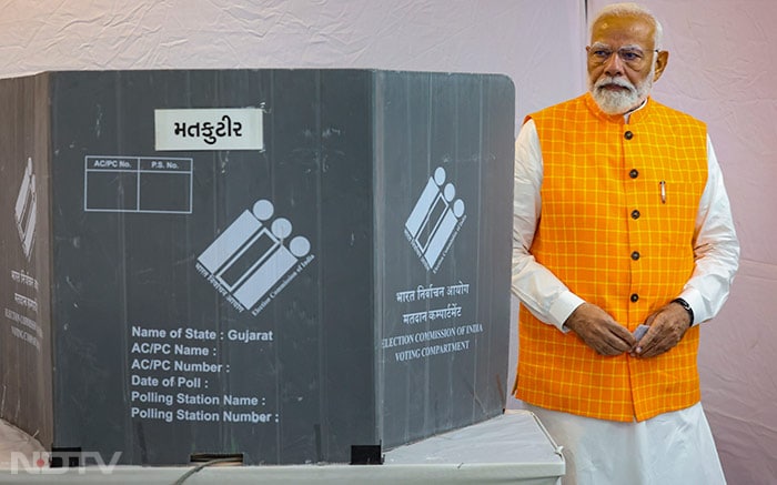 Prime Minister Narendra Modi casts his vote at a polling booth in Ahmedabad during the third phase of Lok Sabha polls.