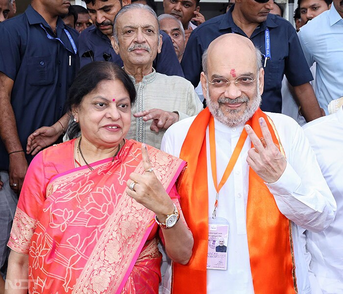 Union Home Minister Amit Shah, his wife Sonal Shah show their ink-marked fingers after casting votes at a polling booth in Ahmedabad.