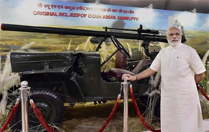 PM Modi poses with jeep of Param Vir Chakra awardee Shaheed Abdul Hameed at the exhibition.
