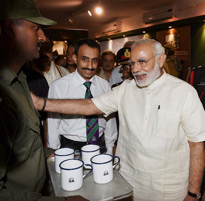 A soldier offers tea to PM Modi at 'Shauryanjali', a commemorative exhibition on Golden Jubilee of 1965 war at India Gate in New Delhi.