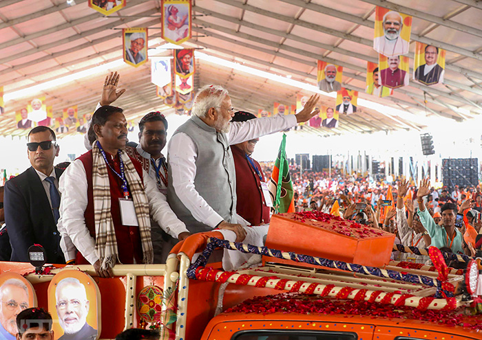 पीएम मोदी खुली जीप में सवार होकर सभा स्थल पहुंचे. लोगों ने मोदी-मोदी के नारे लगाकार और फूल बरसा कर पीएम मोदी का स्वागत किया. फोटो: पीटीआई