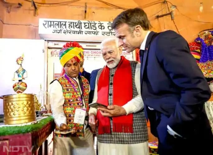 PM Modi explains the UPI digital payments system to French President Emmanuel Macron during his visit to India