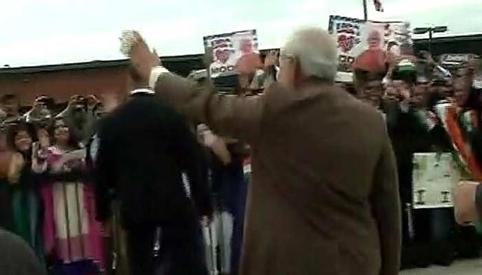 PM Modi waves to the huge gathering of supporters and well-wishers who turned up to greet him at the airport in Washington after his arrival from New York on Monday.